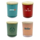 Four glass jars with wooden lids are displayed. The jars are different colors: green with Jetstar, red with Old Spice, green with The Body Shop, and peach with Weller logos.
