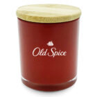 A red jar with a wooden lid featuring the Old Spice logo in white, including a ship icon above the text.