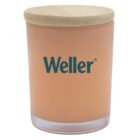 A peach-colored candle in a glass jar with the word Weller printed in green. The jar has a round wooden lid.
