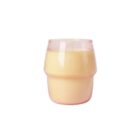 A yellow candle in a transparent, pink-tinted glass holder. The design features a smooth, rounded contour with a slightly wider midsection. The candles wick is centered and unlit. The background is plain white.