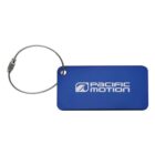 A blue luggage tag with rounded corners, featuring the white text Pacific Motion and a stylized logo. It has a silver metal cable loop for attachment.