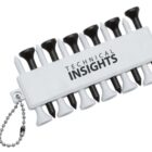 A white plastic holder labeled Technical Insights contains alternating black and white golf tees. A small metal chain is attached to the holder.