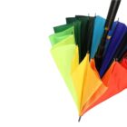 A collection of closed umbrellas displayed in a fan shape, showcasing a gradient of colors from yellow to red, green, and blue, against a plain white background.