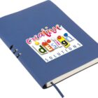 A blue notebook with the words creative design SOLUTIONS on the cover. The title uses colorful and playful fonts with the word design resembling Scrabble tiles. A ribbon bookmark peeks out from the bottom.