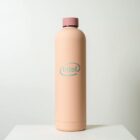 A tall, peach-colored insulated water bottle with a pink lid and the intel logo in light blue on the front. The bottle is set against a plain white background.
