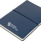 A closed blue notebook with a black elastic band. The cover has a white logo and text that reads Central Clinic Inc. A ribbon bookmark is visible at the bottom.