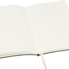 An open notebook with lined pages and a black cover. It has a cream-colored ribbon bookmark placed between the pages.