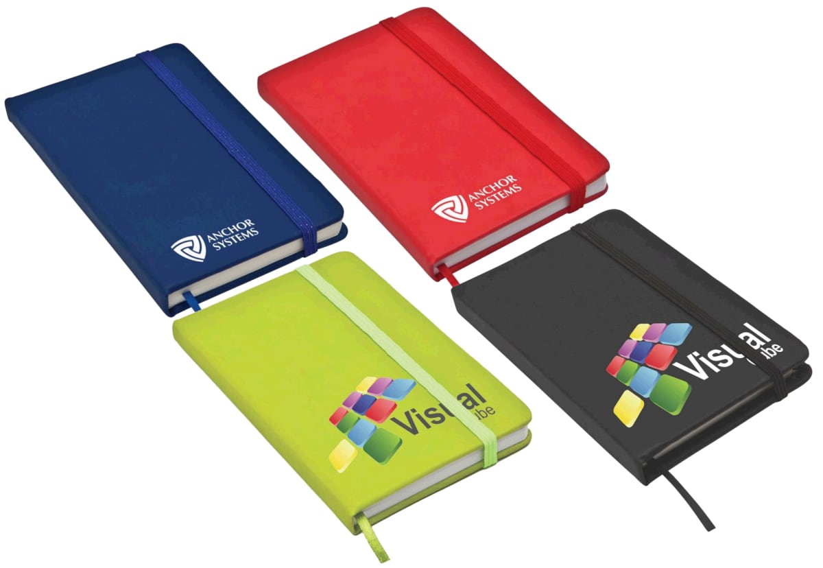 Four colorful notebooks are displayed: a blue one, a red one with Anchor Systems logo, a green one with Vistal logo, and a black one with Vistal logo. They have elastic bands and closed covers.