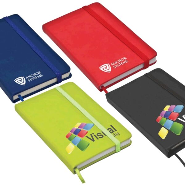 Four closed notebooks are displayed. They are colored blue, red, green, and black, each with elastic bands. The blue and red notebooks have ANCHOR SYSTEMS logos; the green and black notebooks have colorful Vista logos on the covers.