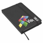 A black notebook with a colorful geometric design on the cover. It has an elastic band closure and the word Visual partially visible. The notebook also features a ribbon bookmark.