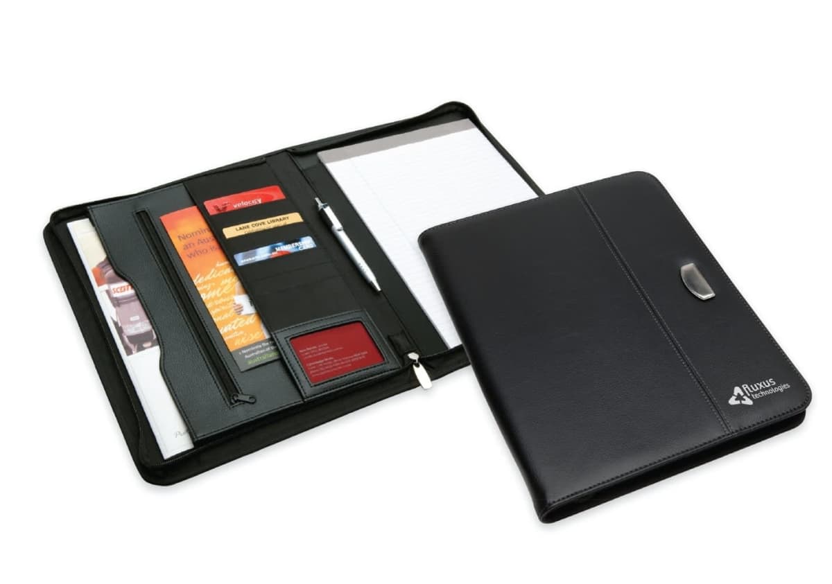 Black leather portfolio organizer open to reveal various compartments. It includes a pen, notepad, card slots, and a zippered pocket. The portfolio has a sleek and professional design with a metal clasp on the cover.