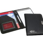 A black leather portfolio folder with a logo on the cover. It is open to reveal a notepad, a pen, and a sleeve with a red booklet inside. The cover flap is partially closed next to the open view.