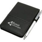 A small black leather notebook with a silver pen in a holder on its side. The notebook has the fluxus technologies logo embossed on the cover.