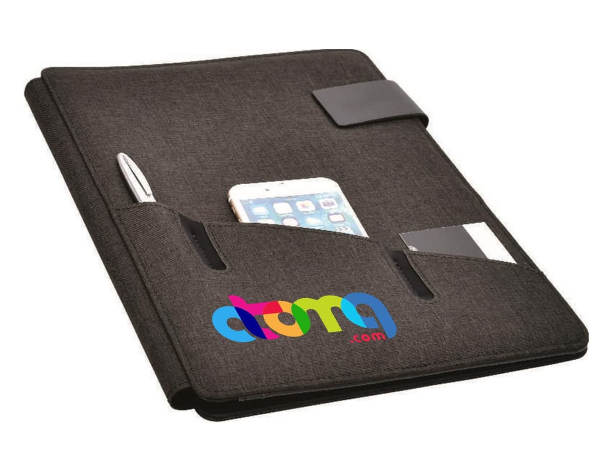 A black fabric organizer with multiple pockets, holding a silver pen, a smartphone, and small cards. The organizer has a colorful logo with the text atma.com on the front.