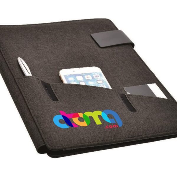 A black fabric organizer with pockets displaying a pen, a smartphone, and a business card. The front has a colorful logo reading atma.com. The organizer is closed with a black elastic strap.