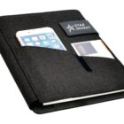 A black portfolio organizer with slots holding a smartphone, two business cards, and a small notepad. The words Star Invest are engraved on a magnetic closure band. The cover has a textured fabric finish.