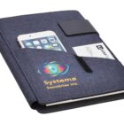 A blue fabric organizer with a smartphone and business card in the front pockets. It features the Systema Securities Inc. logo with a multicolored eye design. A black closure strap is visible on top.