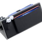 A black rectangular organizer holds a pair of white earbuds, a purple pen, and a blue smartphone with a red case. The organizer is angled, showing various slots and compartments designed for small items.