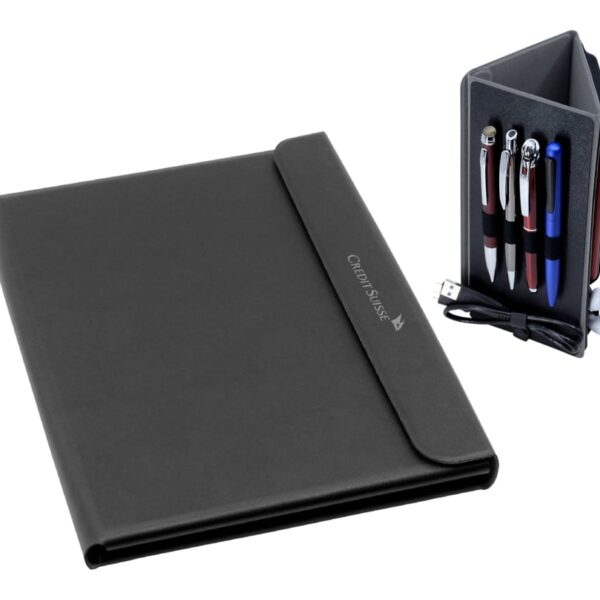 A black leather folder with Credit Suisse embossed on it, accompanied by a black pen holder containing four pens, a USB cable, and a pair of white earbuds.