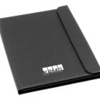 A black leather portfolio folder with the KPMG logo on the front, featuring the distinctive white letter design and four rectangular blocks above the text. The folder is closed and positioned upright on a white background.