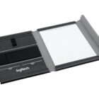 A Logitech folio case open to reveal a lined notepad on the right. The left side has compartments for storing small items. The case is predominantly black with some gray detailing.