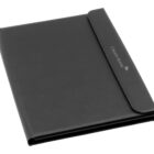A black leather folder with a flap closure, featuring the text Credit Suisse and a logo embossed on the front. The folder has a sleek and professional design.