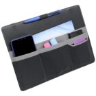 A black organizer with multiple pockets holding a smartphone, pen, envelope, and various small items. It has a sleek design with gray accents.