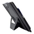 A digital tablet standing upright on a flat surface, supported by a foldable kickstand attached to its back cover. The screen is not visible, and the devices edges are lined with a protective case.