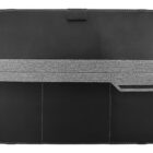 A black leather tablet case with a gray elastic band across the middle. The band features a small handle on the right side. The case has visible stitching along the edges and a fabric tab at the top.