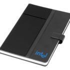 A black notebook with a cover featuring a pocket and a strap closure. The word intel is printed in blue on the lower right corner of the cover.