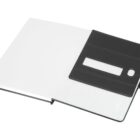Open black and white notebook with a transparent window on the inside cover, showing a pouch and pen holder on the right side.