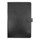 A closed, plain black leather notebook with a magnetic flap closure is centered against a white background.