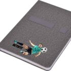 A gray notebook with a textured cover features an image of a soccer player in mid-air, kicking a ball, and the word ACTIFIT printed underneath.