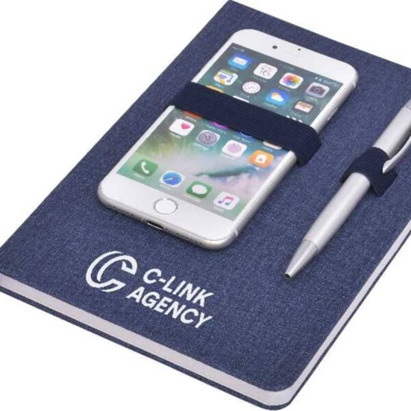 A navy blue notebook with C-LINK AGENCY on the cover, holding a smartphone and a silver pen secured with elastic bands.