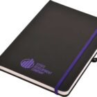 A black hardcover notebook with a purple elastic band and bookmark. The front cover has a purple logo and the text Estate Development Company printed in purple. The edges of the pages are visible.