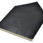 A black, leather-bound sketchbook with slightly visible texture, resting on a white background. The sketchbook is closed, showing the spine and front cover.