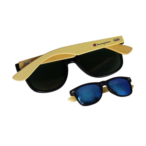 Two pairs of sunglasses with wooden temples are displayed. The larger pair has black lenses, and the smaller pair has blue reflective lenses. The word champion is visible on the wooden temples of the larger sunglasses.