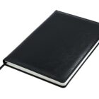 A closed, black leather-bound notebook with a ribbon bookmark lying on a white surface.