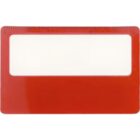 A rectangular red magnifying sheet with a clear magnifying section in the center and measurement markings along the top edge.
