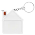 A house-shaped keychain made of white plastic, featuring a triangular roof with horizontal lines and a small red-brown chimney. It is attached to a metal keyring with a short chain.