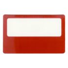 A red magnifying sheet or bookmark with a ruler along the top edge. The central section is a transparent magnifier designed to enlarge text for reading assistance.