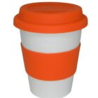 A white reusable coffee cup with an orange silicone lid and grip band. The cup is plain, and the silicone components add color and grip. The design is simple and functional, ideal for hot beverages on the go.