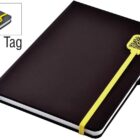 A black notebook with a yellow elastic band and a QR code tag. The cover is plain, and the band wraps around the bottom right corner. A close-up inset shows the tag with the QR code more clearly.
