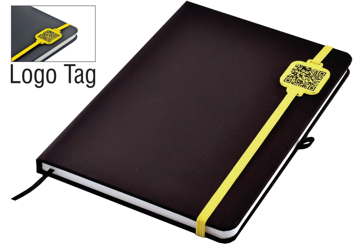 A black notebook with a yellow elastic band and a QR code tag. The cover is plain, and the band wraps around the bottom right corner. A close-up inset shows the tag with the QR code more clearly.