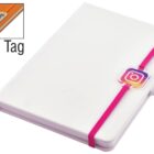 A closed white notebook with a pink elastic band across the cover. The band holds a small Instagram logo charm. The top left corner shows a close-up of a logo tag.