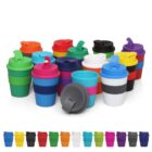 A collection of colorful reusable cups with lids, arranged in multiple rows. The cups come in various colors, including red, blue, green, yellow, and white, each featuring silicone bands and matching lids. A single lid is shown separately.
