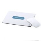 A white mouse pad with a light blue oval containing the text SHOPonline.com is on a white surface. Next to it is a sleek, white, wireless mouse.