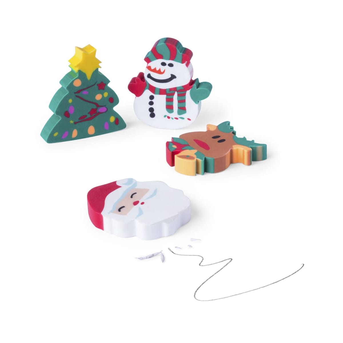 Four festive erasers: a decorated Christmas tree, a snowman with a scarf, a reindeer, and Santa Claus with his hat and beard. Small white eraser shavings are scattered nearby on a plain background.