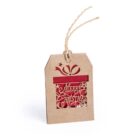A brown gift tag with a cut-out design of a present and stars, revealing a red background. The words Merry Christmas are intricately cut into the tag. A twisted string is attached at the top for hanging.