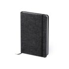 A closed, textured black notebook with a black elastic band and ribbon bookmark. The cover has a subtle fabric pattern.